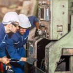 Engineer checking machine maintenance service with team working Engineer checking machine maintenance service with team working together teamwork in steel heavy factory
